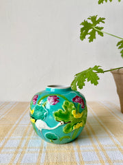 Turquoise ginger jar with stork and flowers in relief